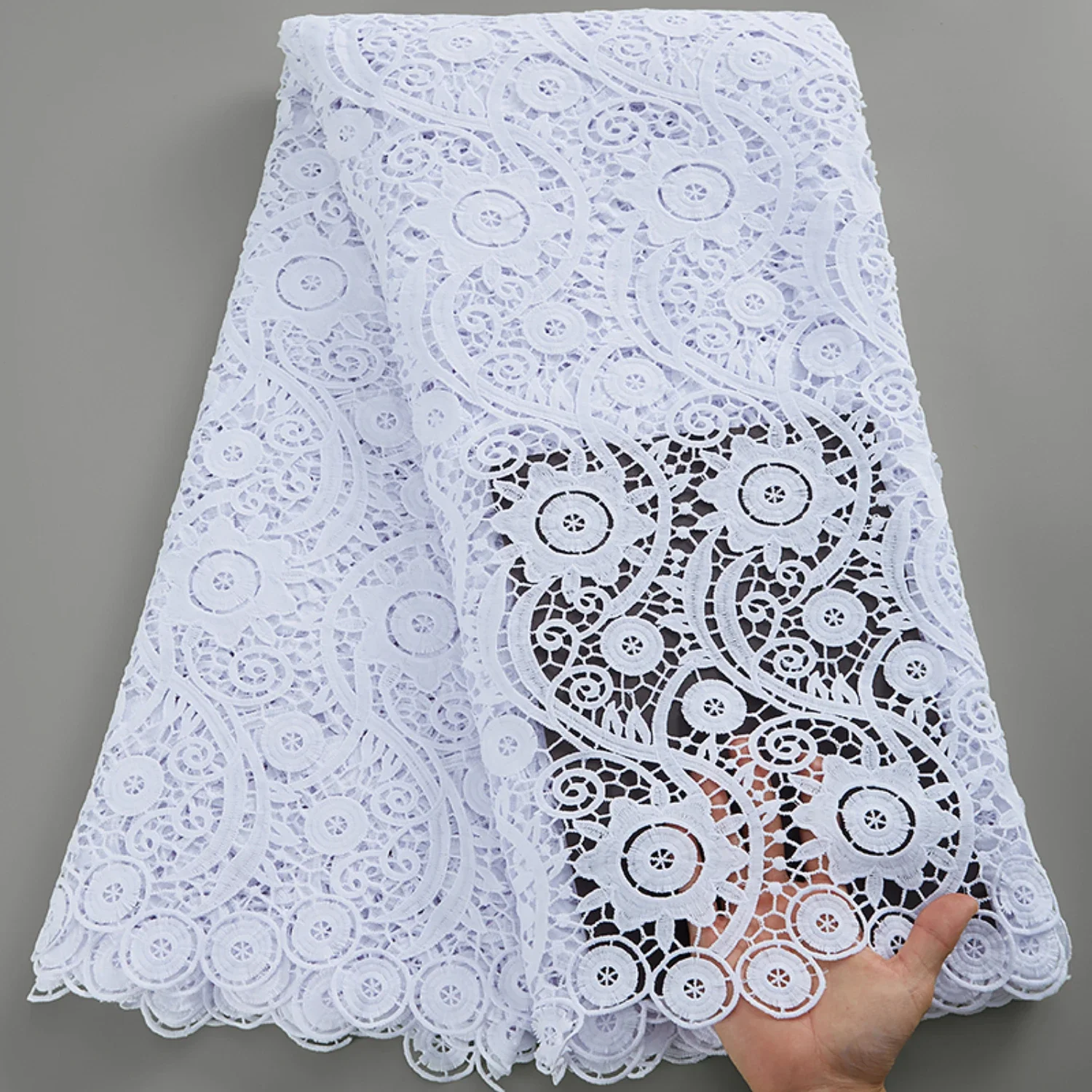 

High Quality, Elegant and Sophisticated African Guipure Cord Lace Fabric in Luxurious White with Delicate Embroidery Detail. Per