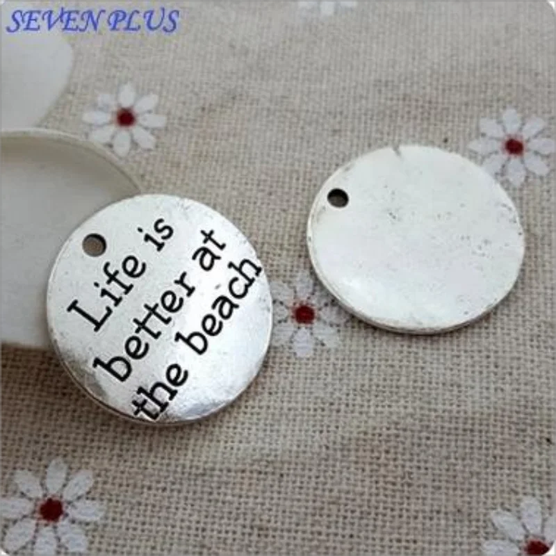 Top Quality 10 Pcs/lot Diameter 23mm Life is better at the beach Antique Silver plated Round Disc Quote Message Charms Pendant