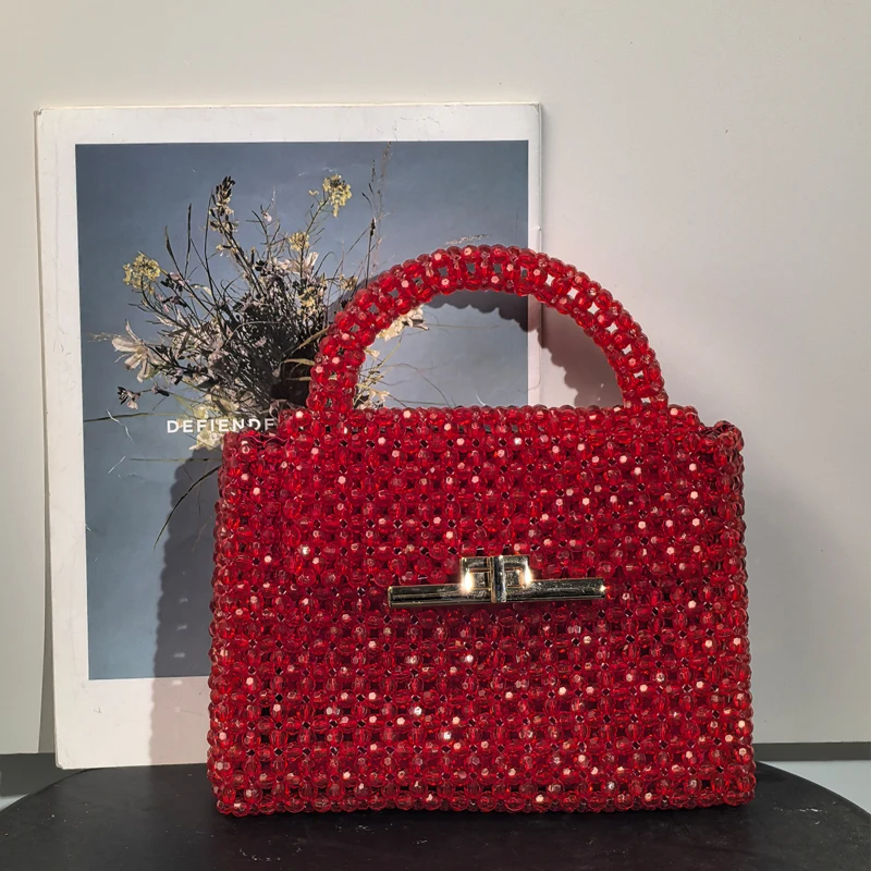 

A Stunning Red Beaded Handbag with Chic Metallic Clasp Exuding Elegance and Vintage Fashion-Forward Statement Luxury Handbags