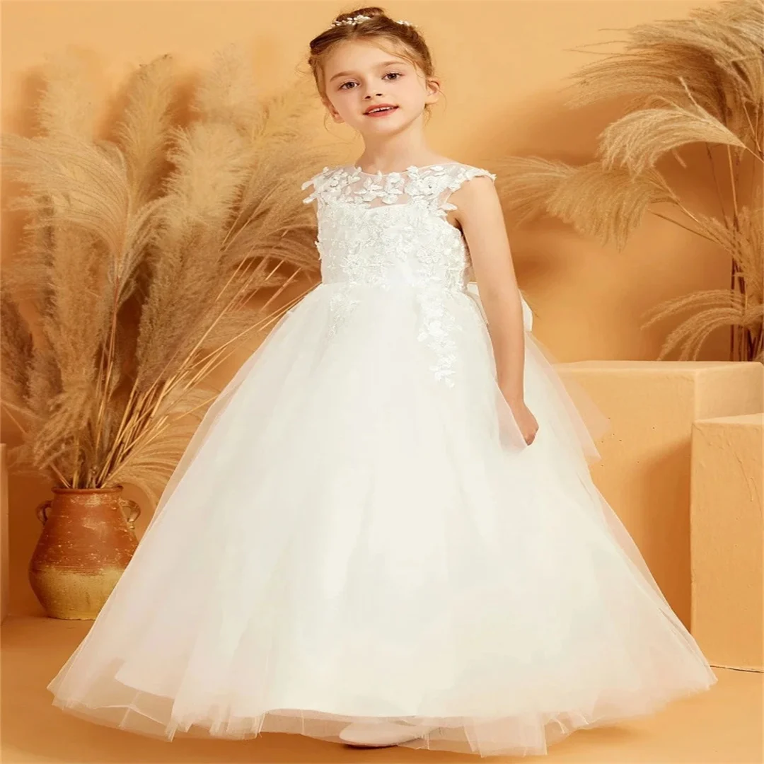 فستان زفاف مخصص لعيد الميلاد مع فيونكة بدون أكمام فستان فتاة الزهور البيضاء من التول مزين بالزهور لحفلات التواصل المقدس