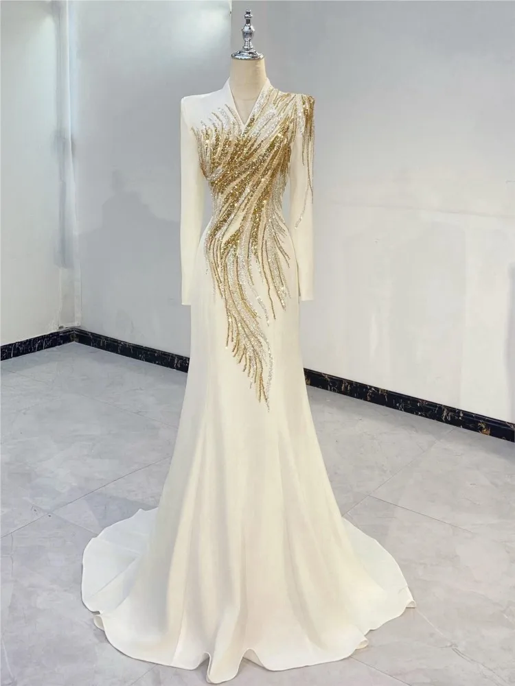 The host wore a long elegant and luxurious dress with light Chinese style featuring white long-sleeved shirt deep collar