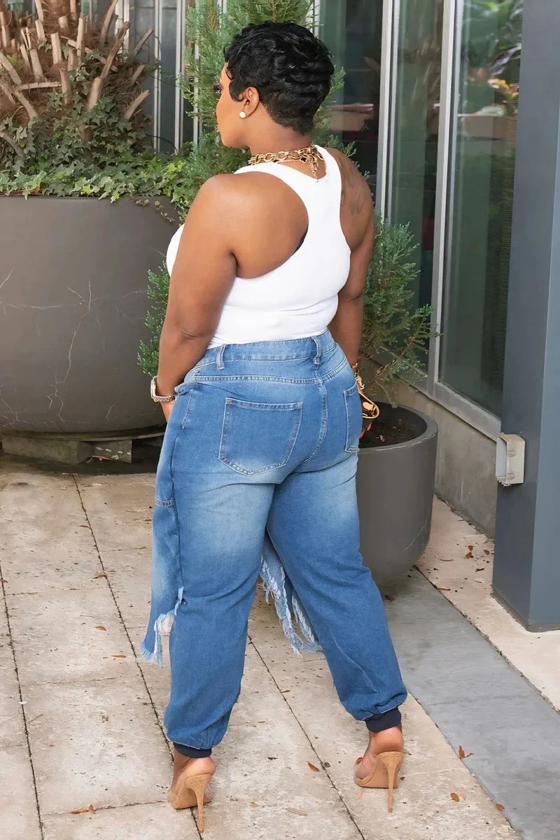 Damskie obcisłe jeansy z dziurami, sznurowaniem i frędzlami - asymetryczne, postarzane, jasno niebieskie denimy z średnim stanem.