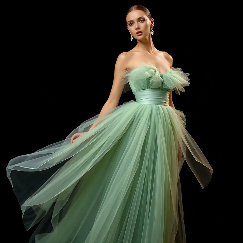 

Elegant Green Tulle Gown With Off Shoulder Design And Flowing Skirt Features Layered Fabric And Cinched Waistline Highlighting F