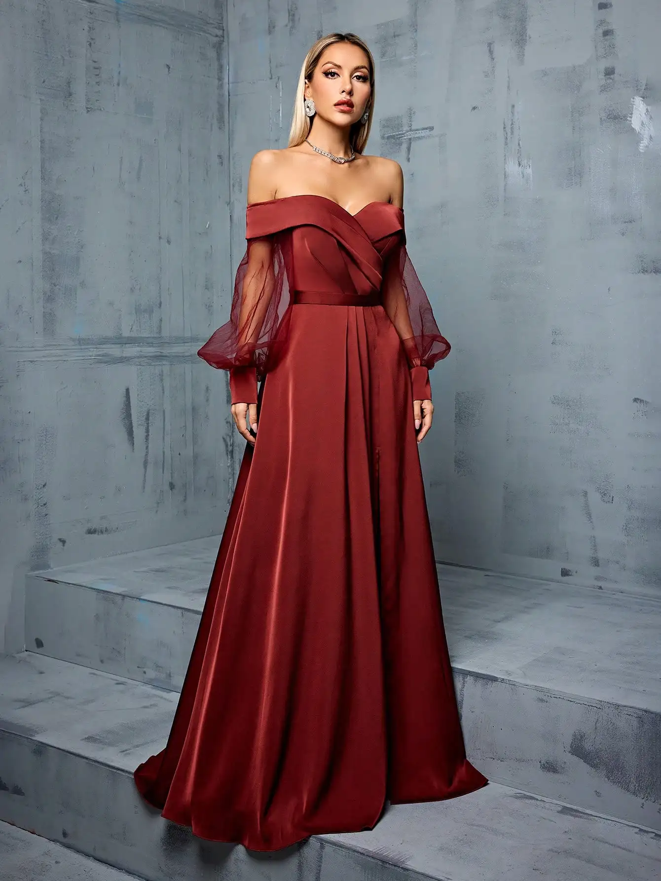 Bridesmaid's floor-length gown with off-shoulder neckline, mesh-satin paneling, and side slit