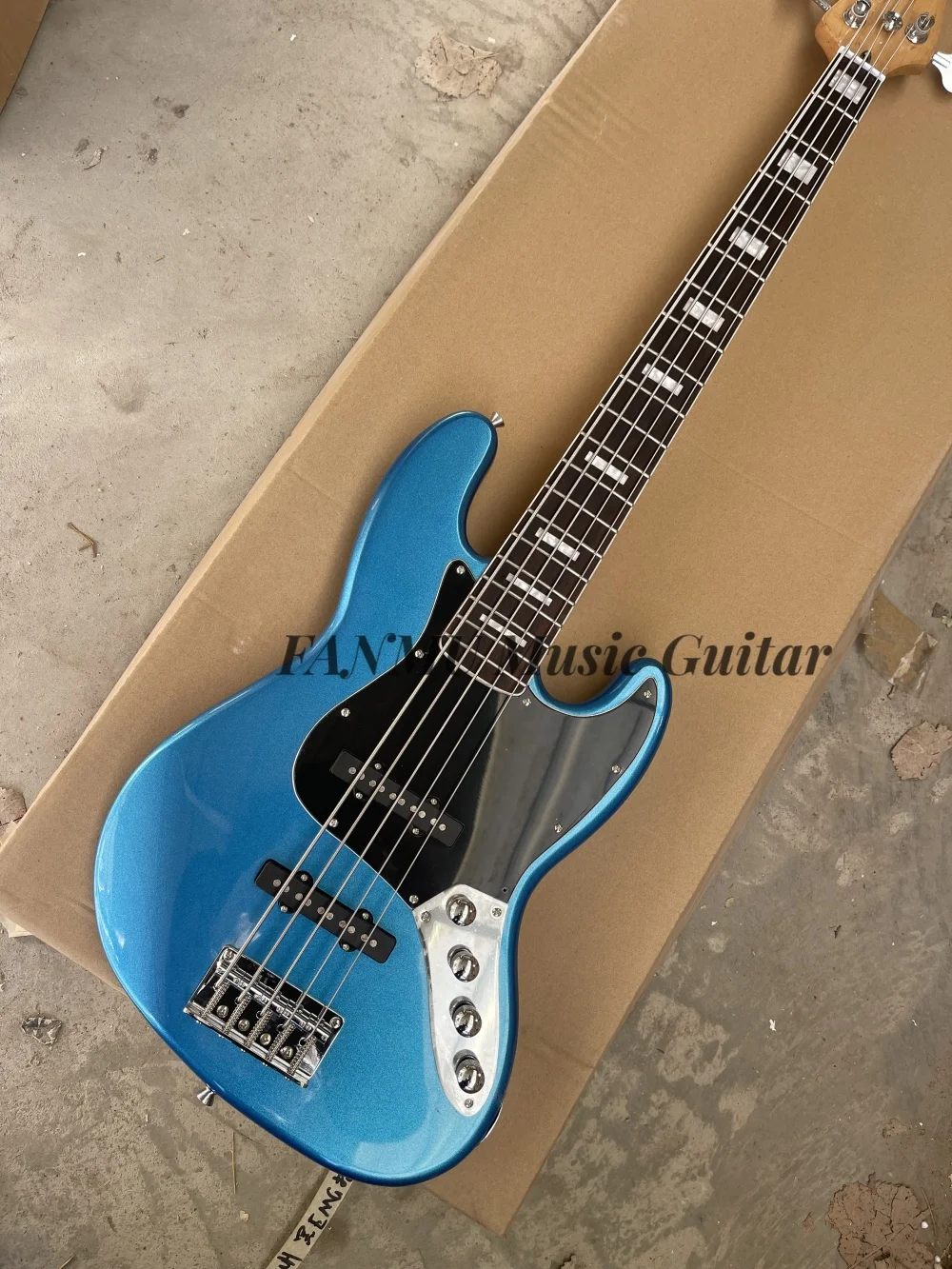 5 string Metallic blue guitar,  fixed bridge, solid wood body rosewood fingerboard, black pickup guard, active battery