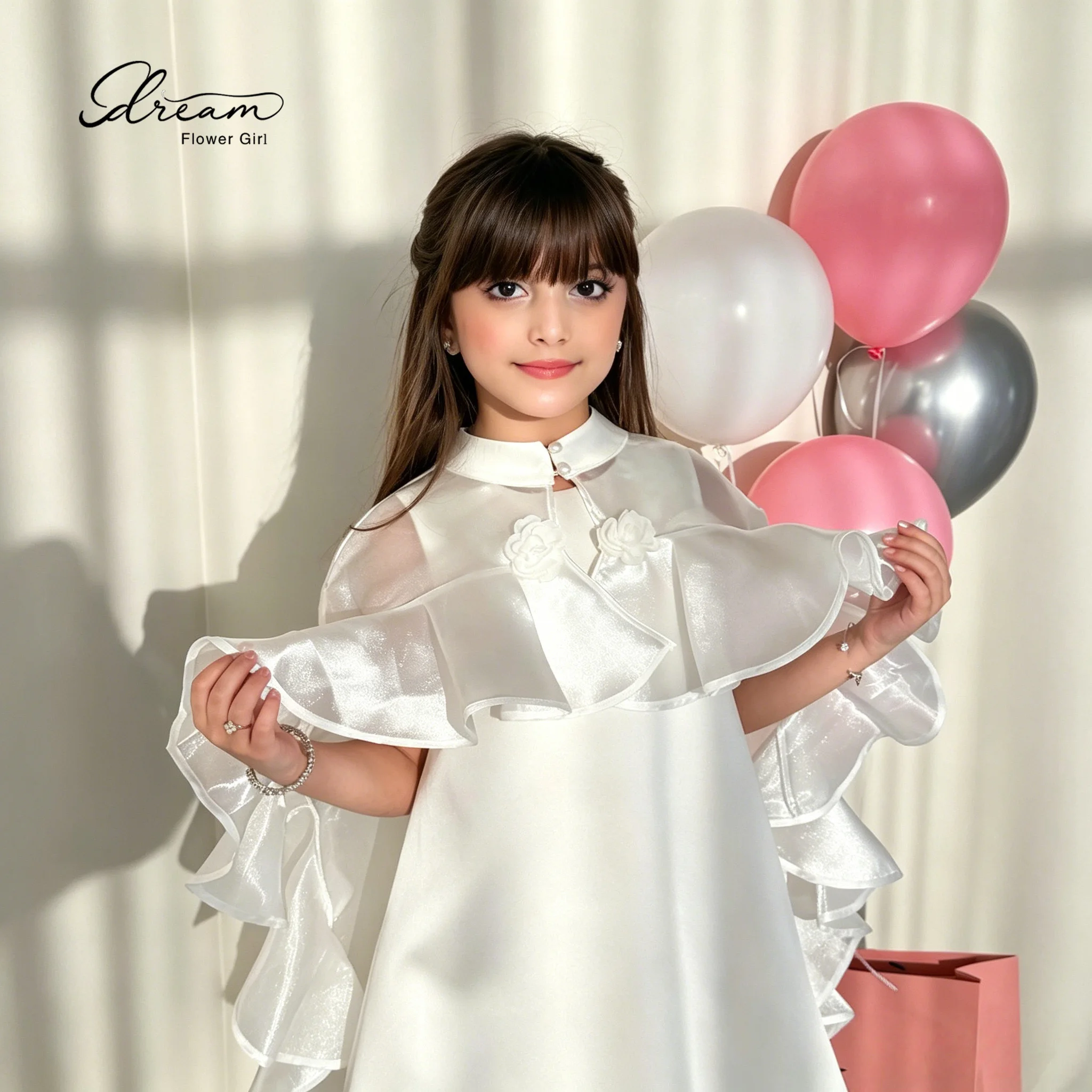 The flower girl's ivory round-neck sleeveless A-line knee-length formal party dress, with a matching color tie-style shawl.