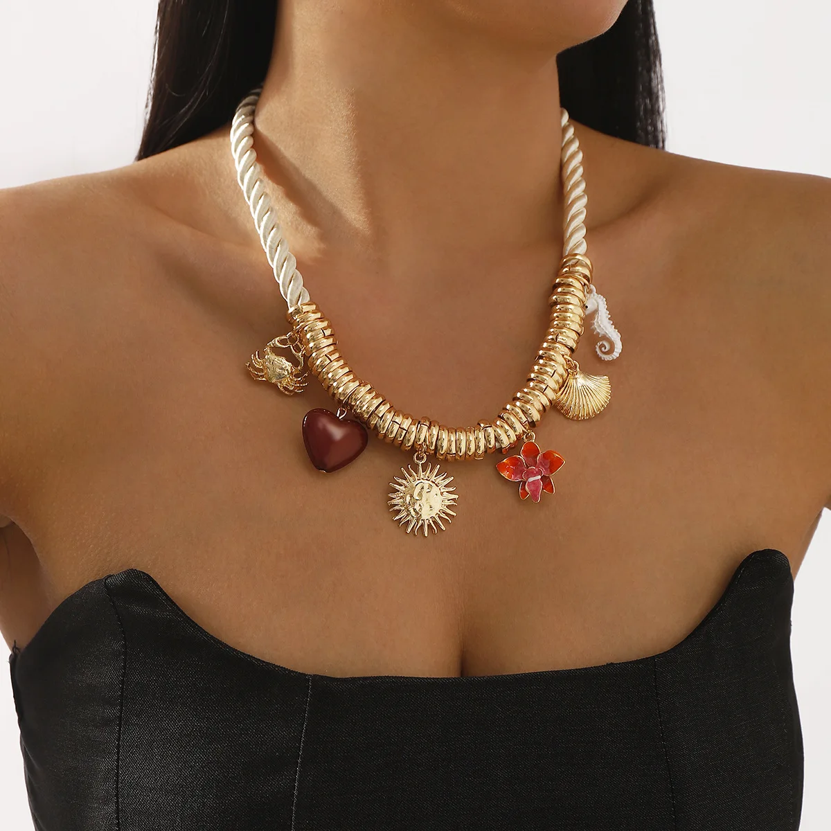 Popular marine-themed crab, seahorse, shell, heart, flower, and sun pendant with thick rope necklace.