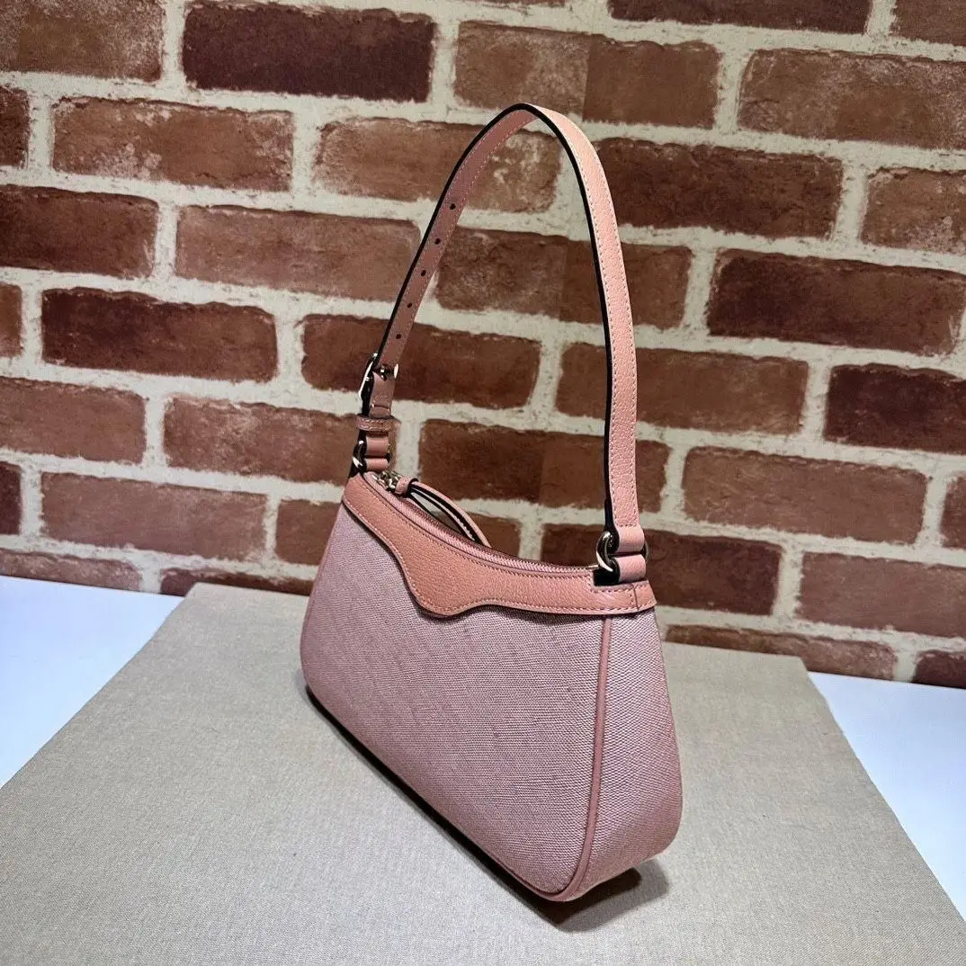 Pastel pink contrasting leather edge shoulder bag, lightweight textured fabric, minimalist design.