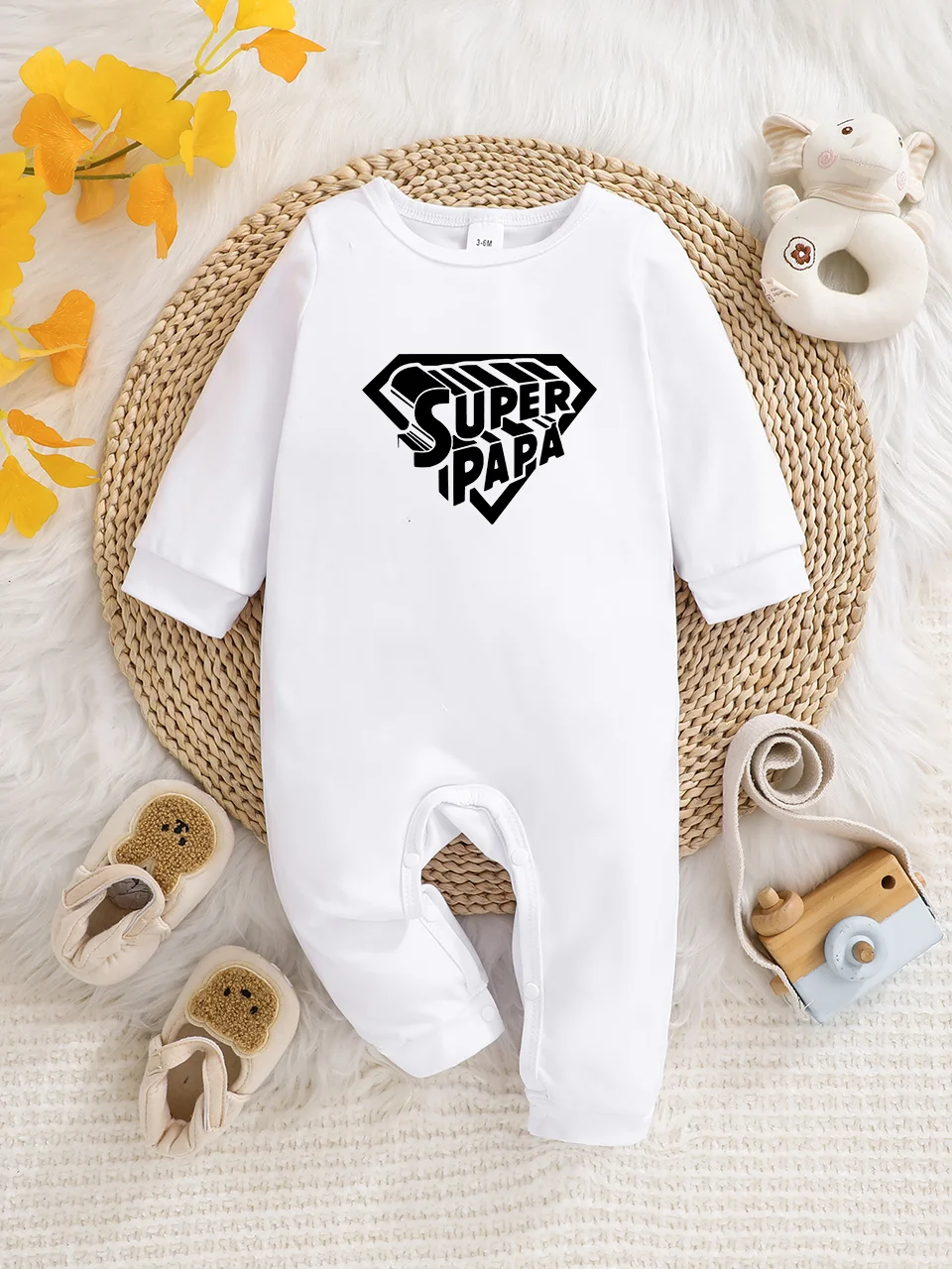 A baby long-sleeved onesie with interesting letter prints. It features a buttoned design for easy putting on and taking off, and