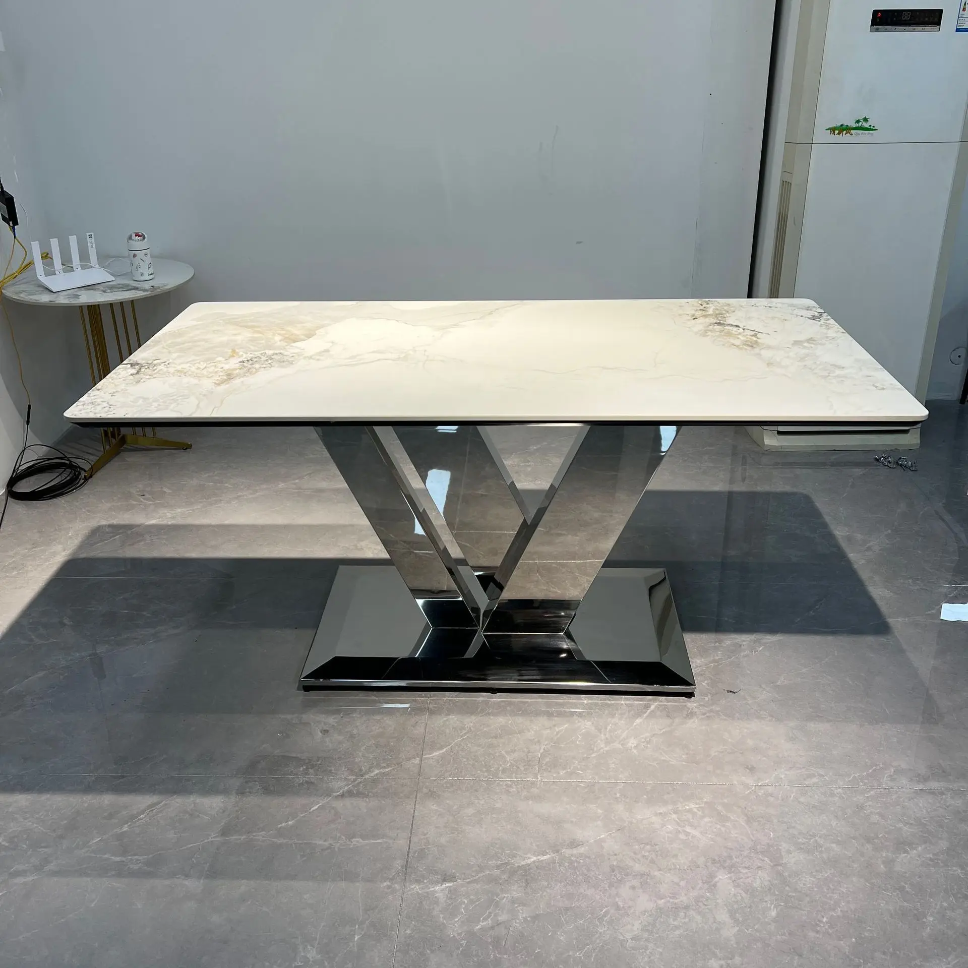 

New rock slab dining table Modern simple home dining table Stainless steel designer high-end dining table