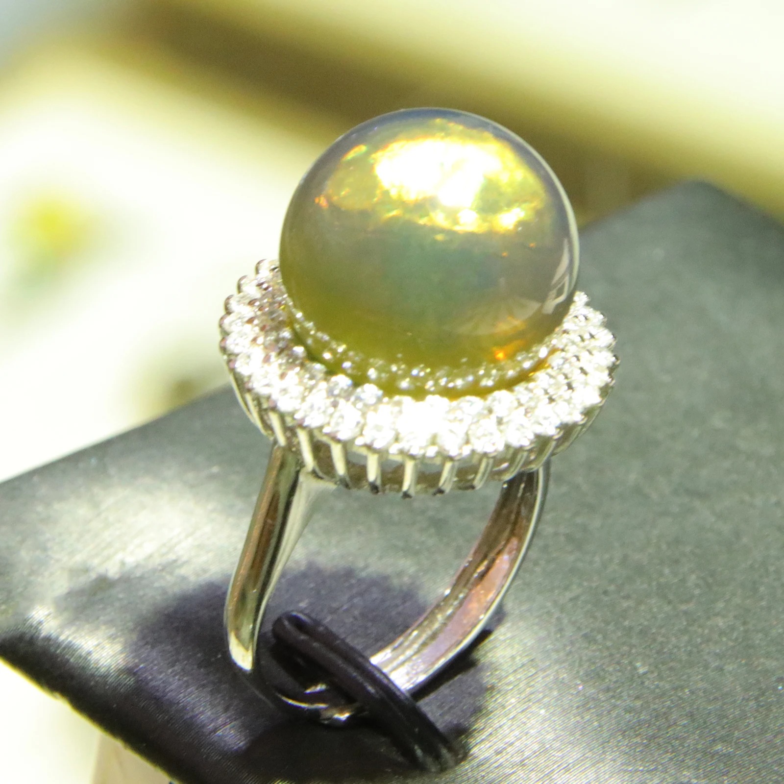 

Anniversary Gift for Her: 15mm Blue Amber Ring with Sparkling Halo Setting | Adjustable Sterling Silver Ring