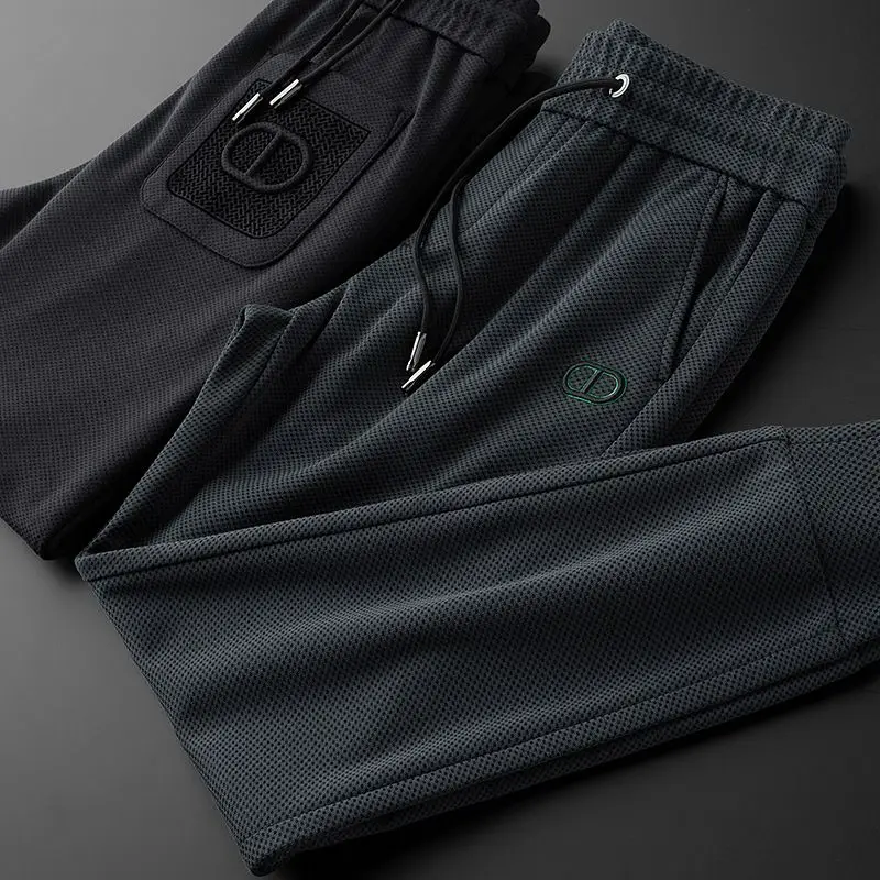 Pantalones delgados para hombre, pantalones deportivos informales con letras, pies de corbata ajustados, pantalones protectores de productos europeos de gama alta