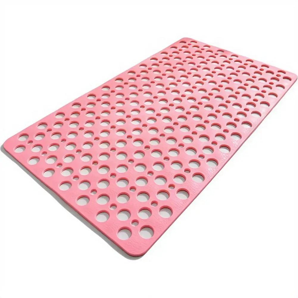 White 3D bath mat with suction cups and raised massage bumps on wet floor.