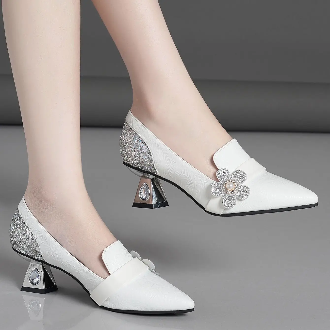 Delicate high-heeled pumps with pointy flowers and rhinestones