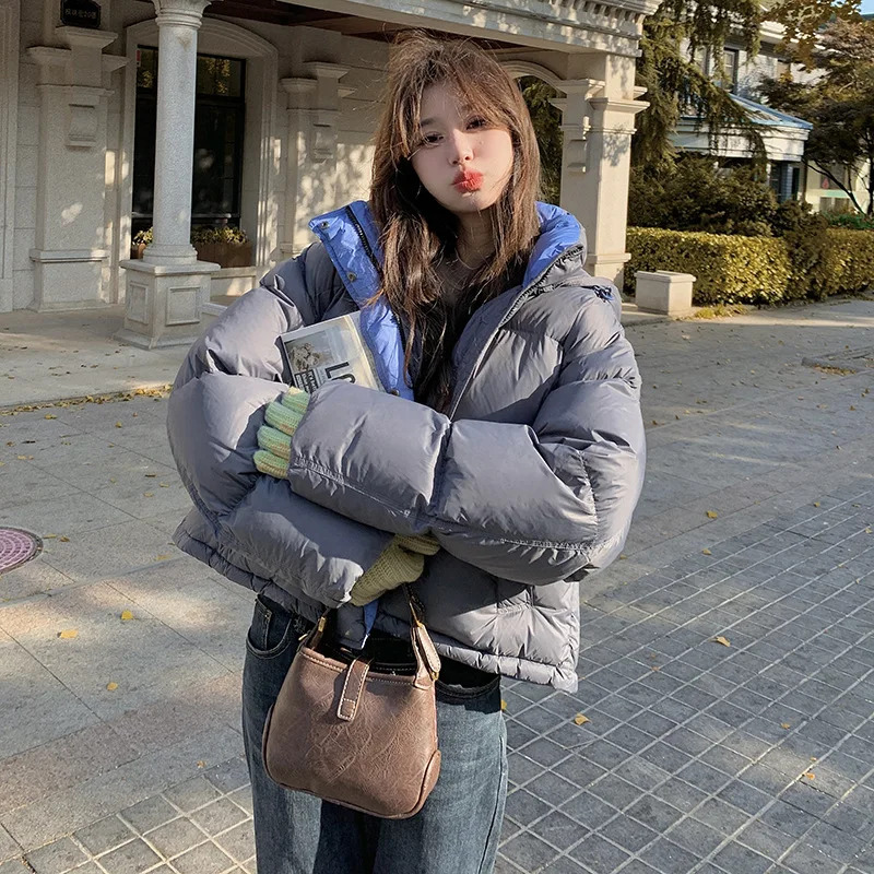 Kurtka puchowa damska z kapturem, blokowana kolorystycznie, zimowa 2025, nowa koreańska wersja, luźny krój, gruba i ciepła, uniwersalna kurtka typu chleb.