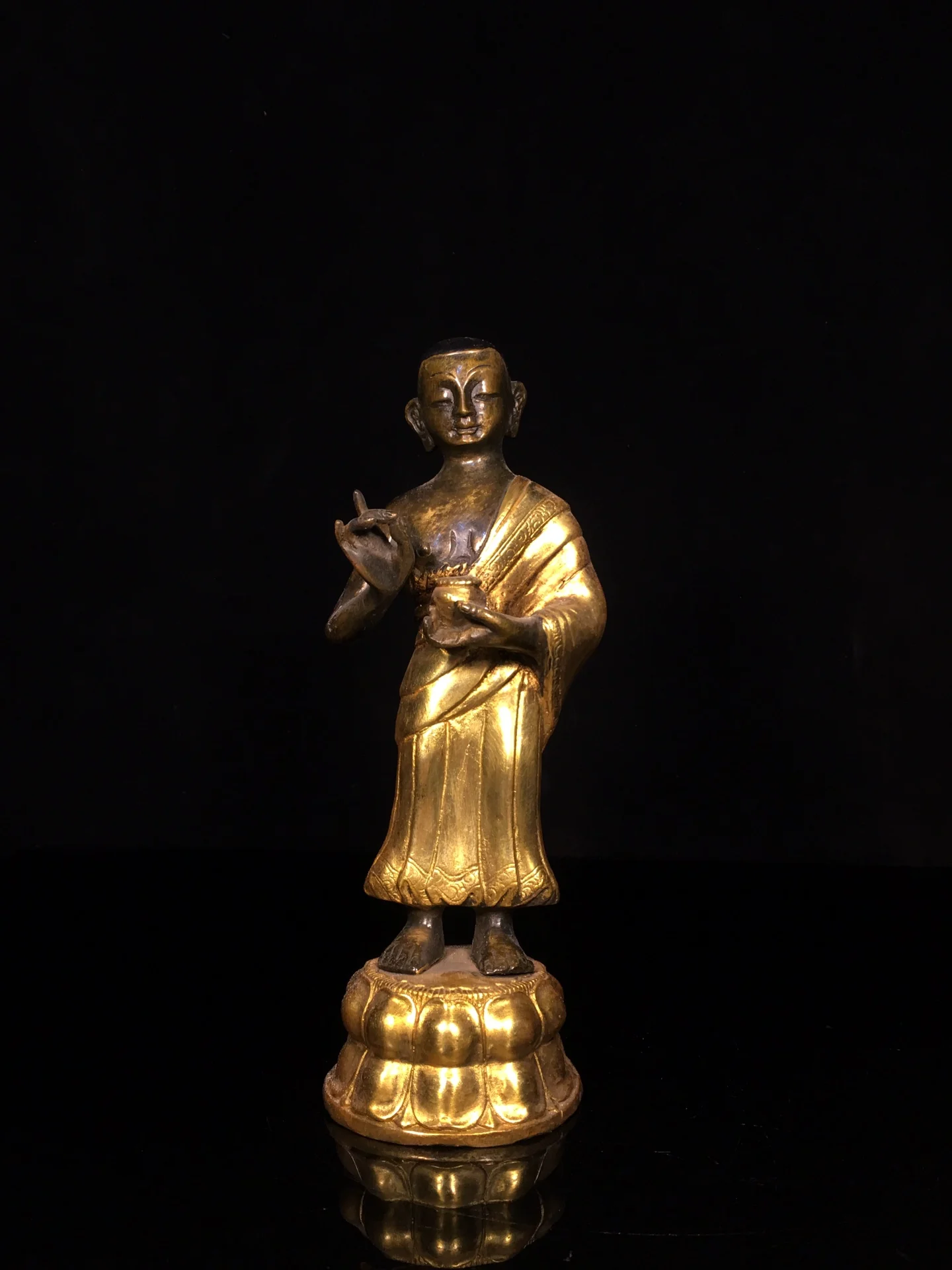 A finely crafted gilt bronze standing Buddha statue, with an aged patina. statue