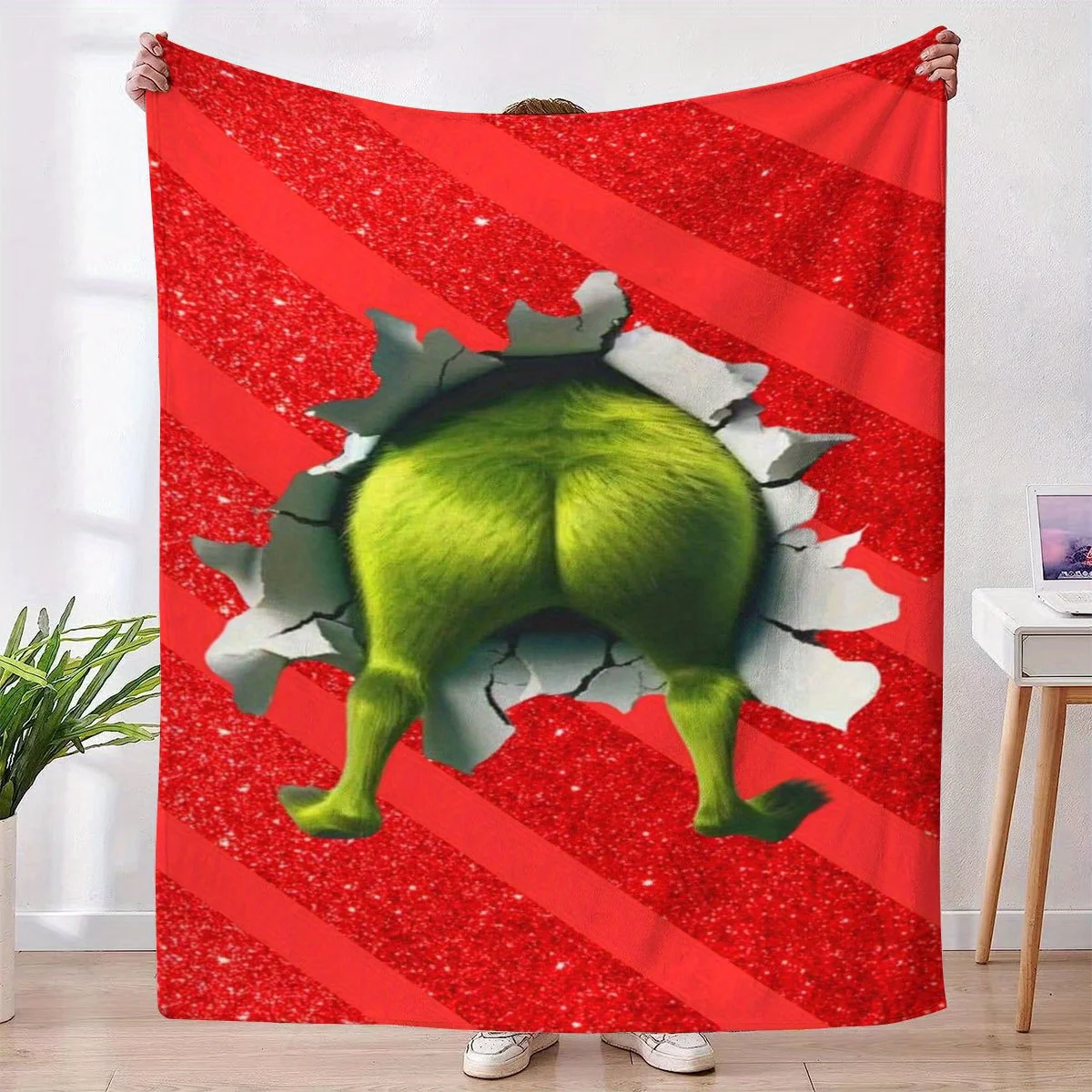 A plush wool blanket featuring the image of a mythical monster's buttocks. It is comfortable and suitable for both home use