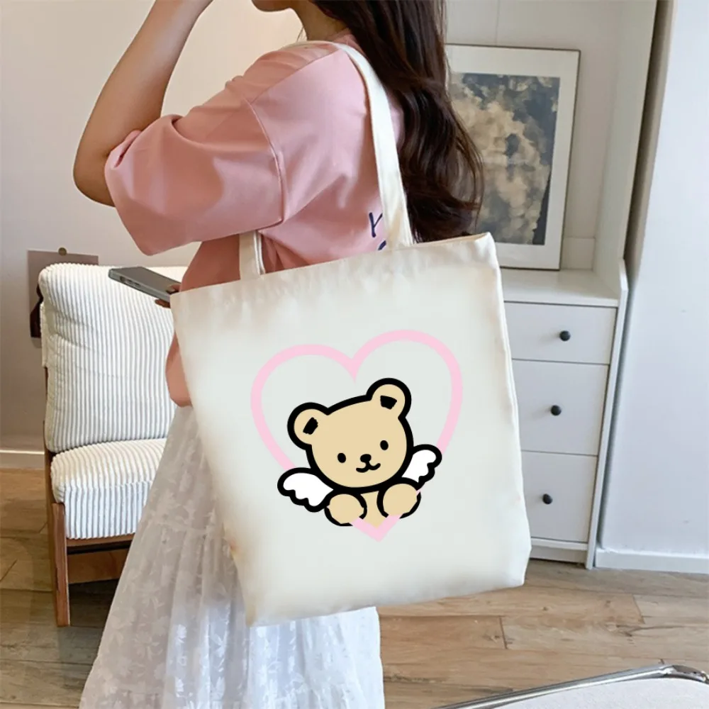 

Стильная и экологичная холщовая сумка-шоппер с принтом милого ангела-медведя для женщин, идеально подходит для ежедневного использования, походов за продуктами и посещения школы.