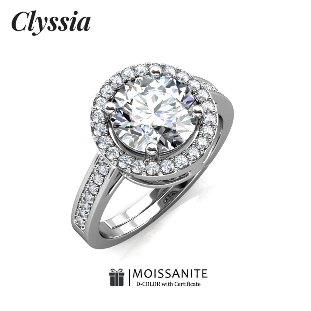 

CLYSSIA Муассанит Круглое бриллиантовое кольцо с ореолом Вечность Свадебная вечеринка Ювелирные изделия из стерлингового серебра 925 пробы с сертификацией GRA Прочный