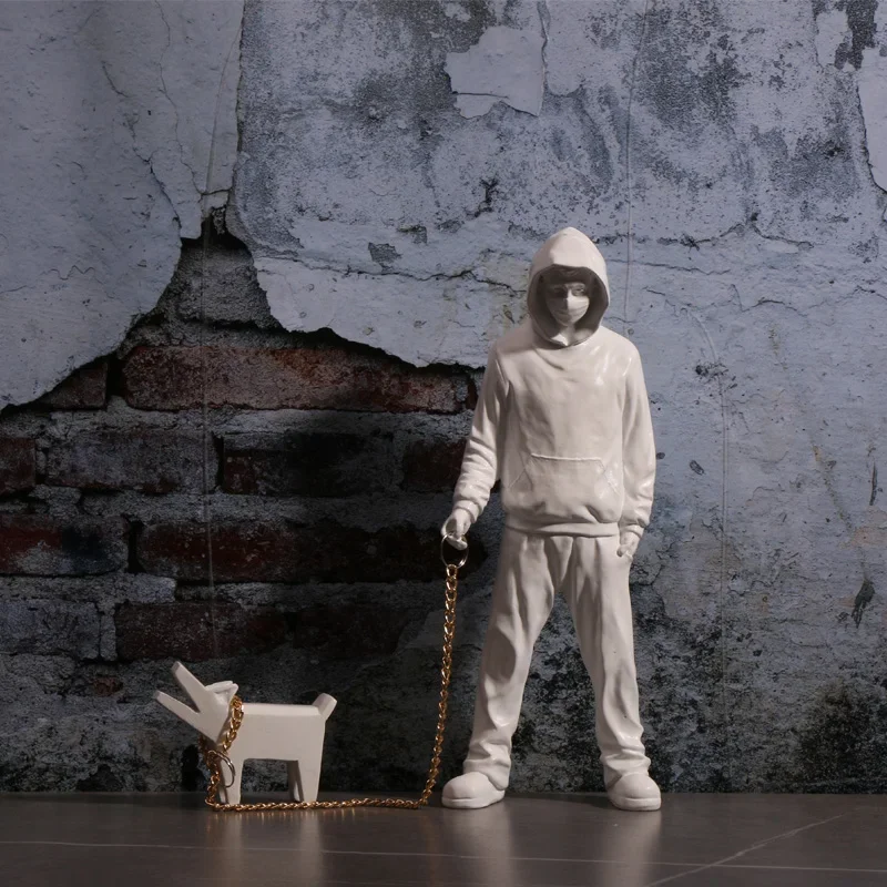 

Banksy a trendy man playing with dogs, white fashion toys, art sculptures and ornaments