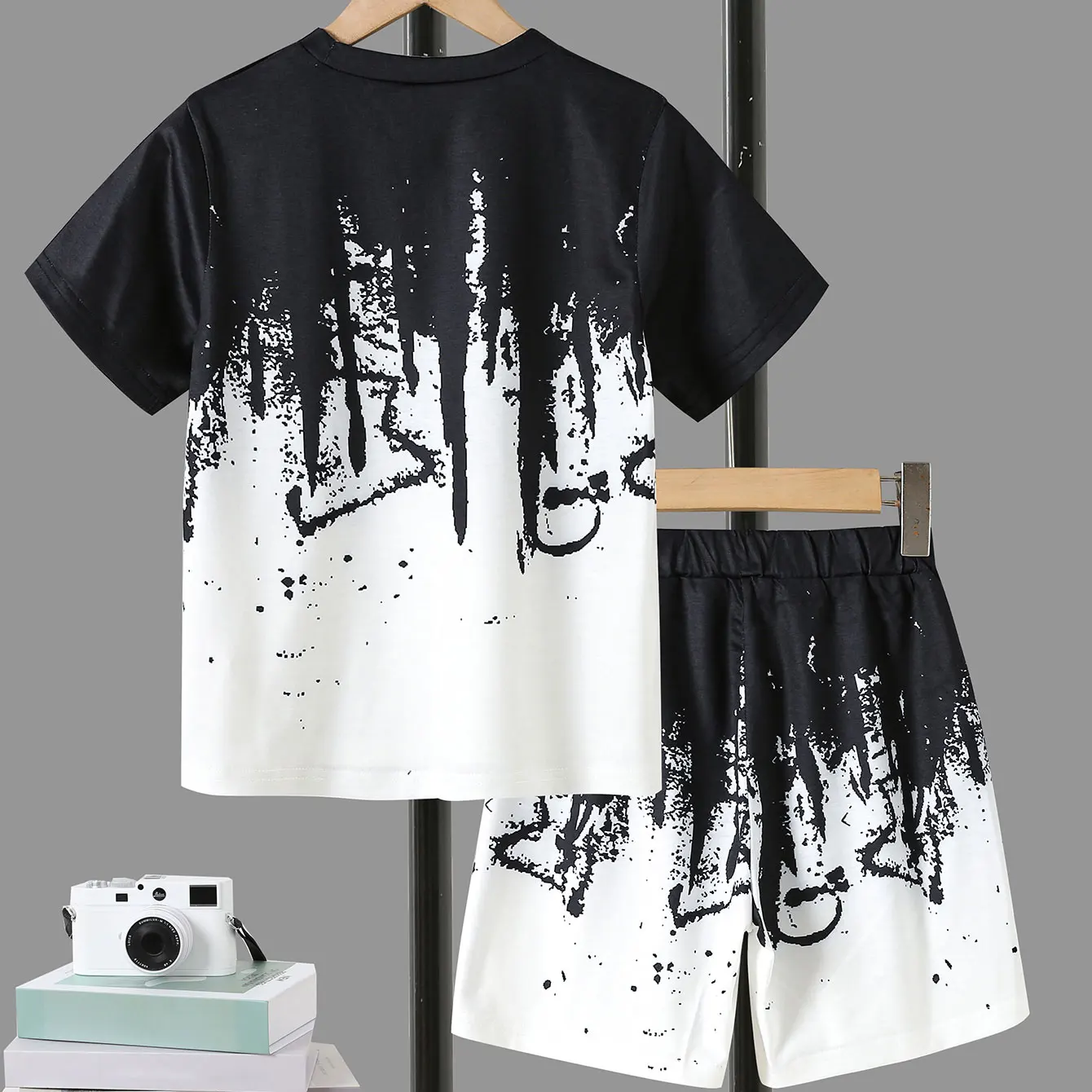 Boys\' Summer Set: Cool Black & White Round-neck T-shirt with Slanted Pocket, Paired with Matching Shorts for Casual Play.