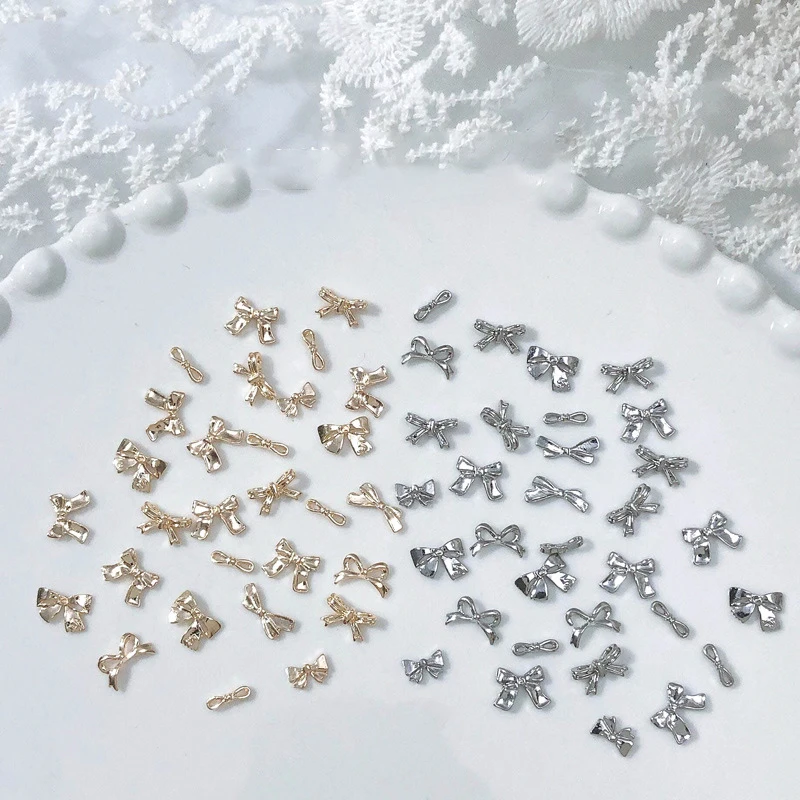 50/100 sztuk srebrne metalowe kokardki Nail Art Charm 3D stop srebrny/złoty Bowknot wstążka części do dekoracji paznokci DIY luksusowe akcesoria do Manicure