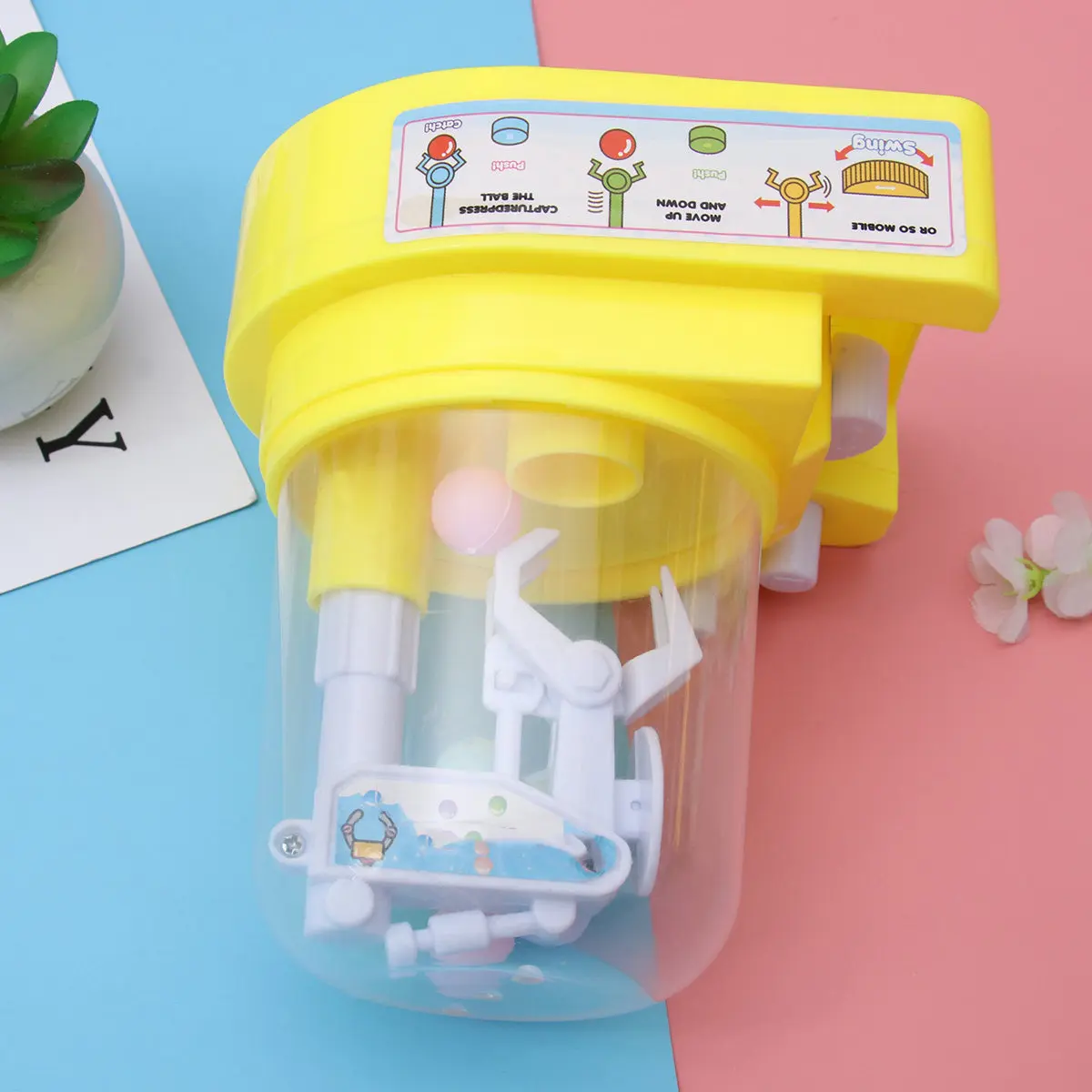 1Pcs Candy Grabber Machine Claw Yellow Mini Mechanical Arm Handheld Catcher for Kids Improve Hand Eye Coordination Holiday Party
