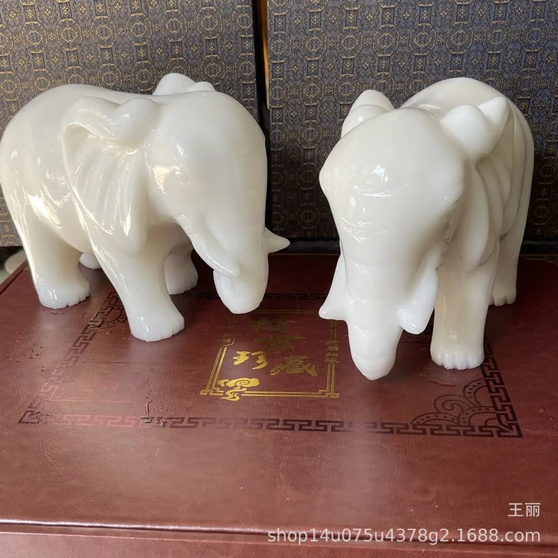 Comparable to Hetian jade, this auspicious ornament features Afghan jade with floral, bird, and elephant motifs, a Chinese-style