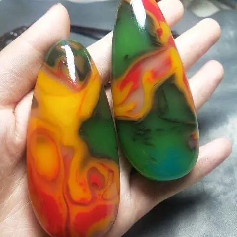 

Natural Xinjiang silk winding colorful jade rough stone handle piece male jade chalcedony agate hand play piece