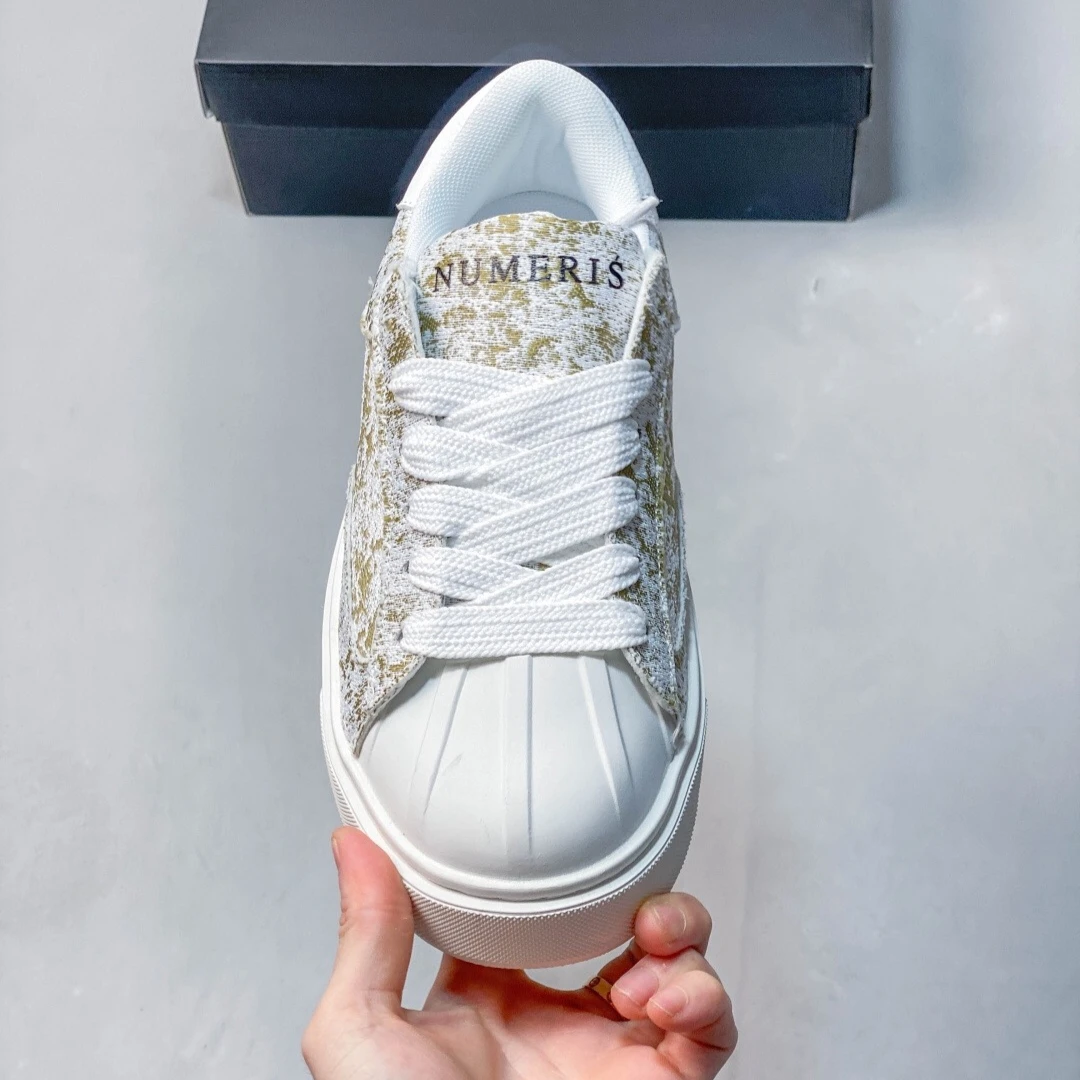 Unisex Platform Sneakers in White Featuring A Shell Toe Design Contrasting Suede and A Low-top, Lace-up Style for Everyday Wear