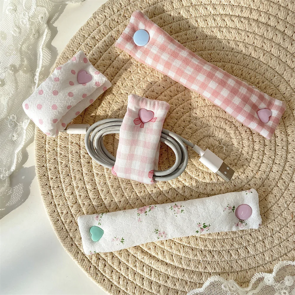 Data cable storage buckle, charging cable winding device, headphone cable storage fabric