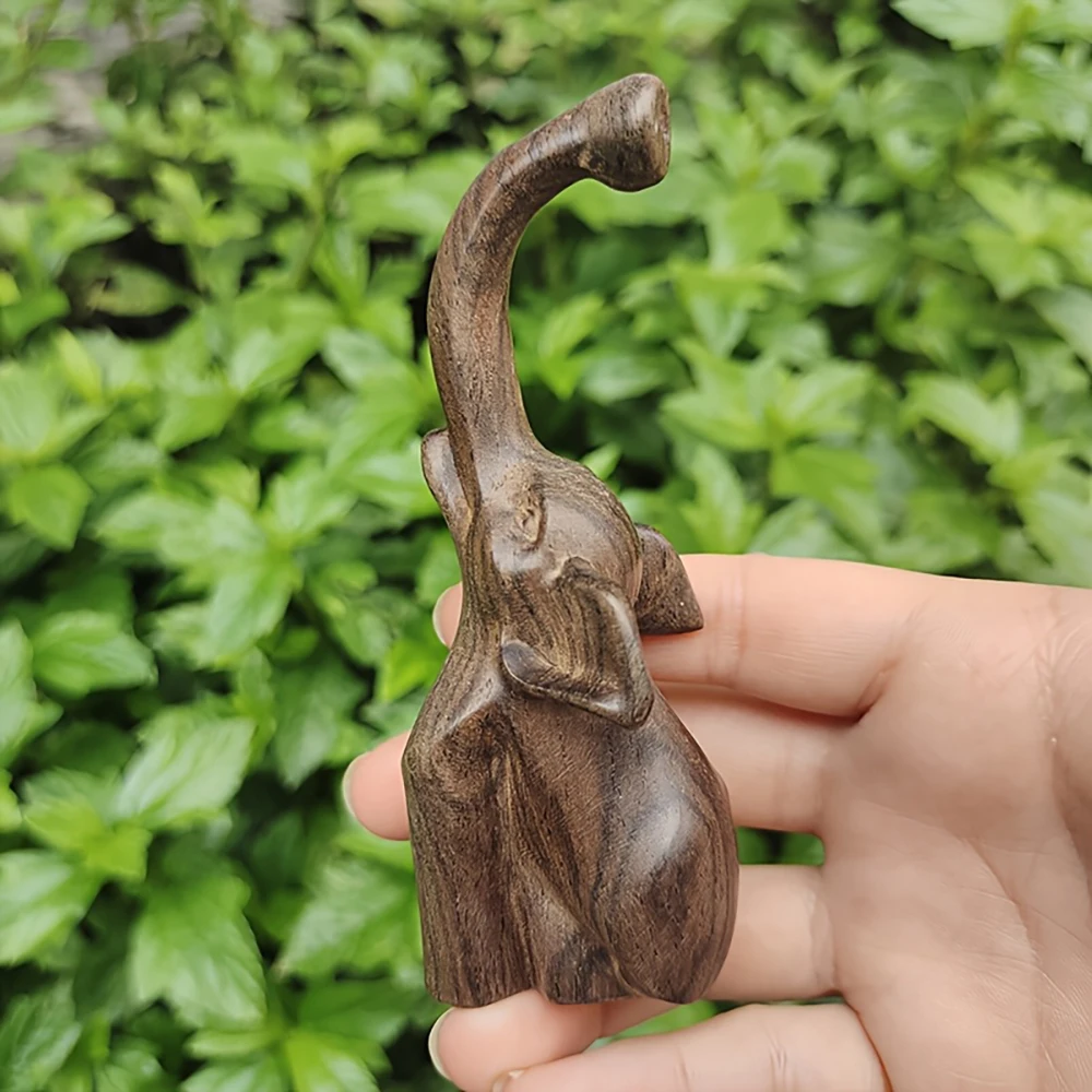 Solid wood elephant ornament, with raised trunk and ear contours, suitable for office use. Simple line design, a legacy of craftsmanship, offering peace and protection. A premium decorative piece for multiple settings