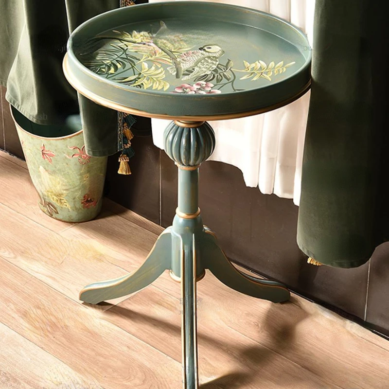 American small coffee table with painted corners, a few round tables near the living room sofa and hand-painted retro furniture.