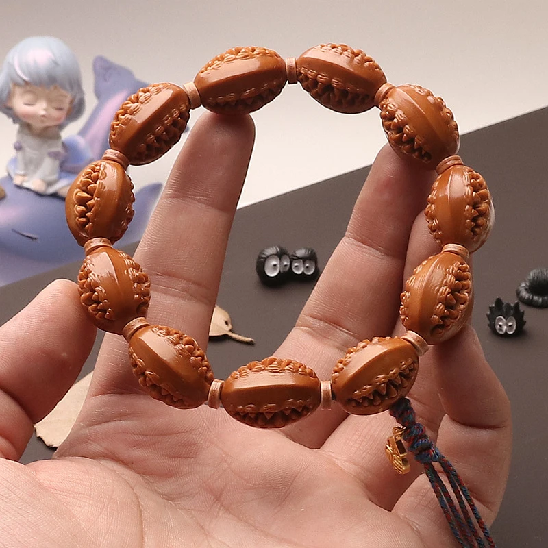 Hand-carved olive pit with iron core, three-sided carving, iron fragment, single-loop tassel design, unisex, hollow-out design