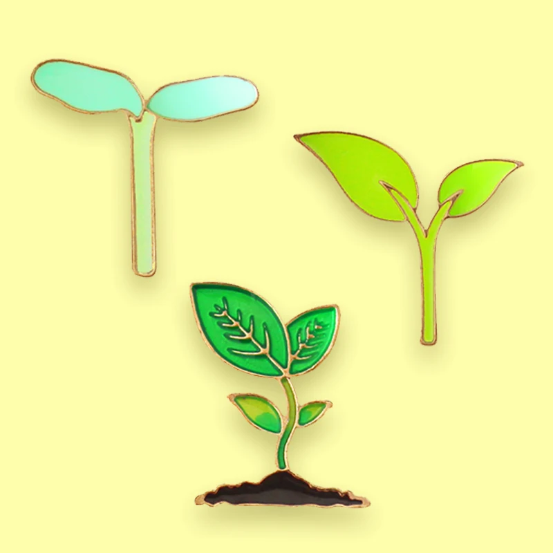 

Металлическая брошь в виде зеленых растений