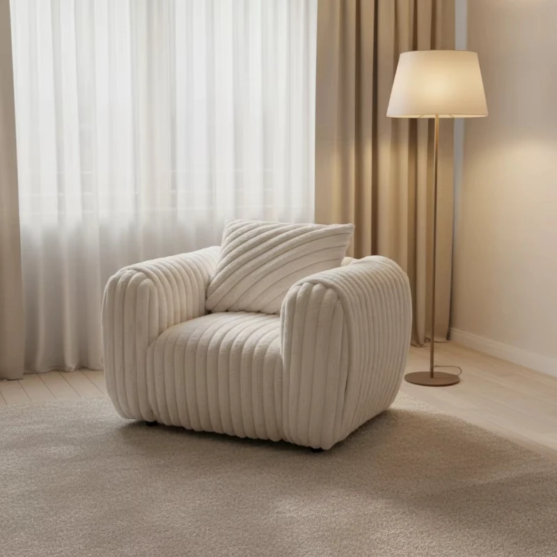 

Cream corduroy chair with wooden legs and back cushions, suitable for use in hotel lounges