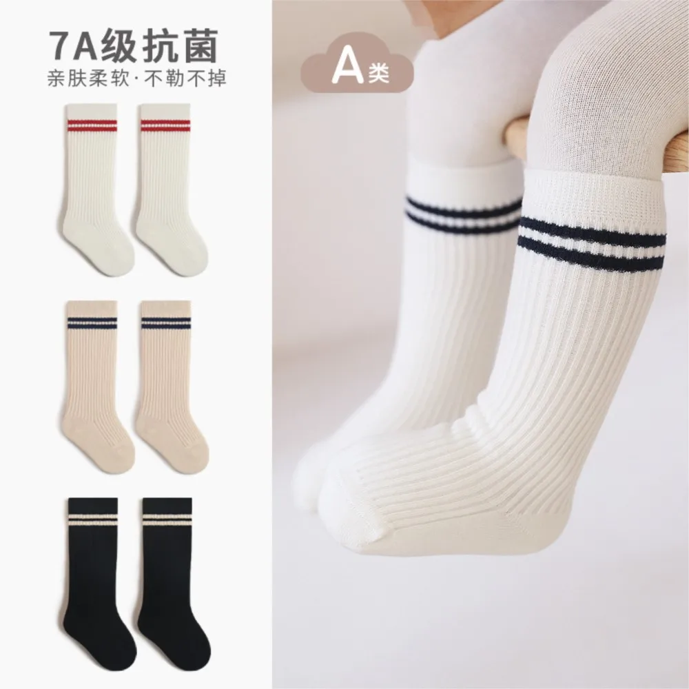 

Spring and autumn children socks cotton students college wind solid color parallel bars boneless antibacterial high socks.