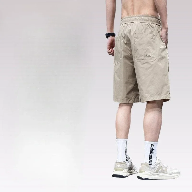 Celana Pendek Kargo Pria Panjang Solid Bermuda dengan Tali Tarik Celana Pendek Pinggang Setengah Elastis Longgar Lebar untuk Pria Desainer Saku