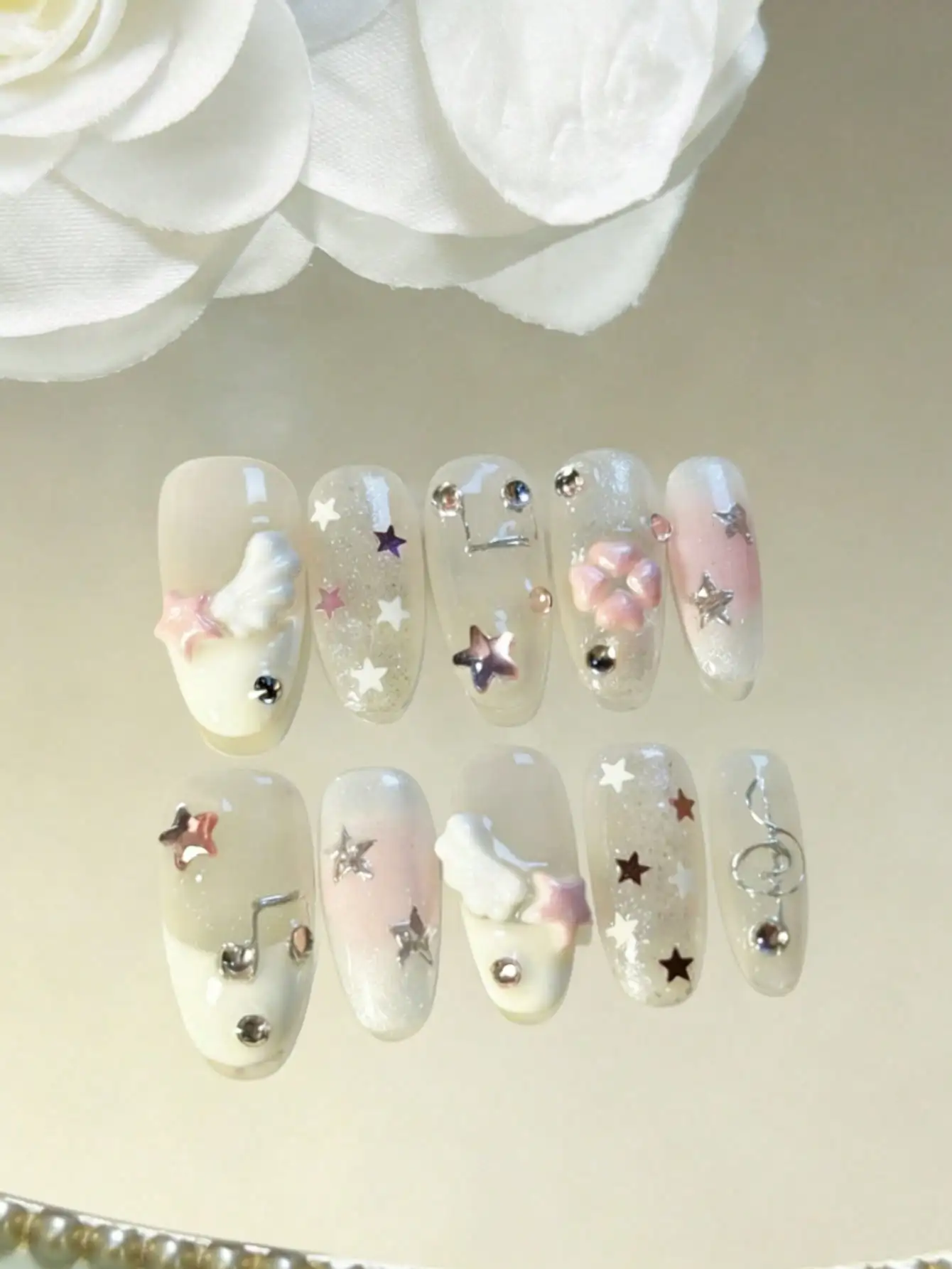 

10 piece handmade oval nail stickers, Y2K style gradient pink and white, 3D wings, stars, notes, diamond stickers