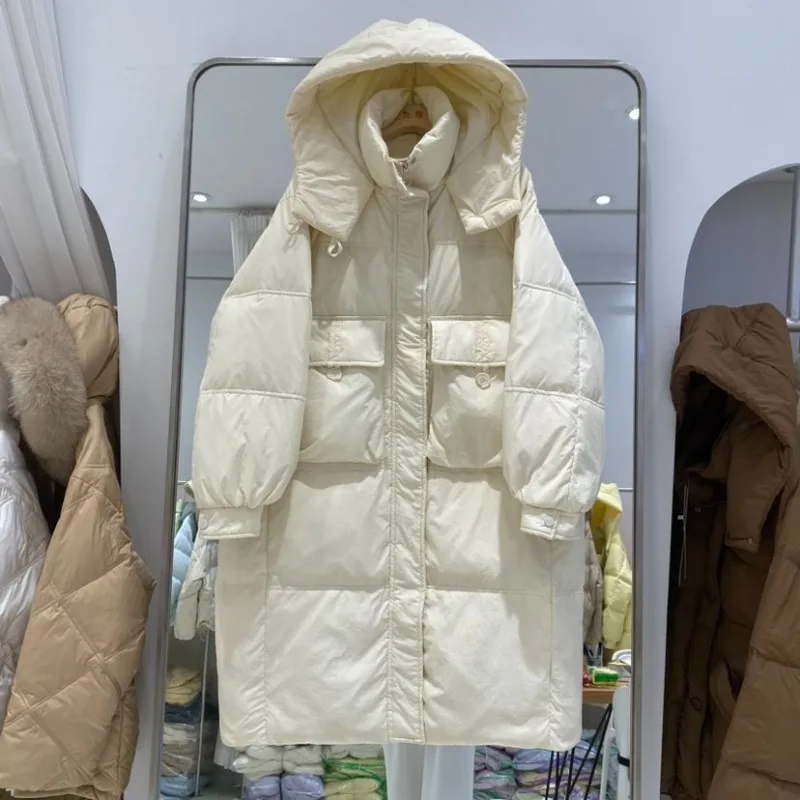Giacca da donna media e lunga sopra il ginocchio 2025 Nuova versione coreana Moda allentata ispessita con cappuccio Piumino d'anatra bianco Marea