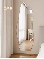 Single sided minimalist haircut with irregular mirror hanging on the wall and dedicated light for hair salons