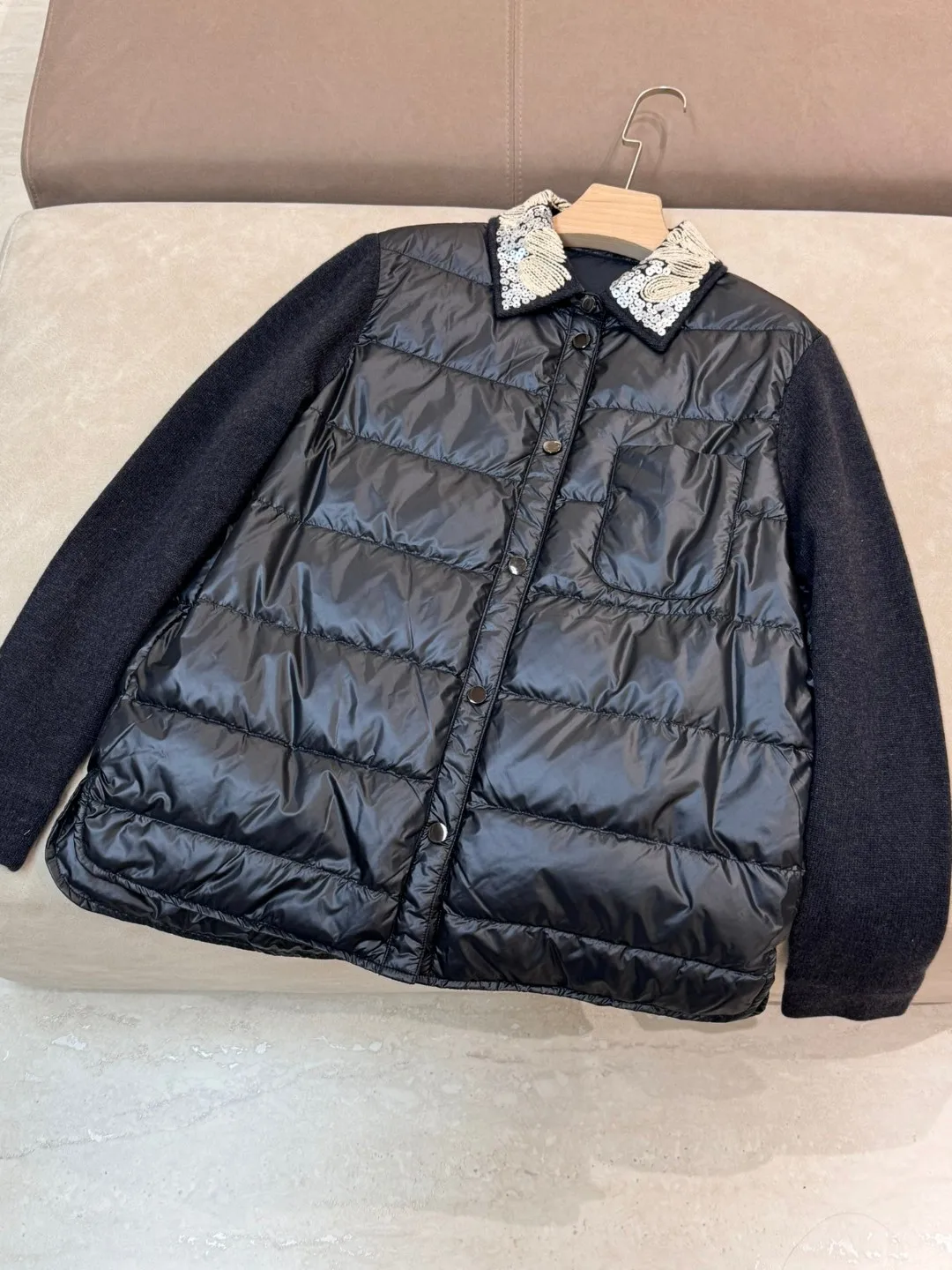 Exquisitely trimmed luxurious solid color down padded single breasted jacket