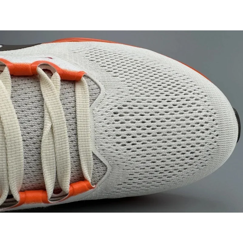 Nike Air Zoom unisex cream and orange sneakers, breathable mesh, Zoom cushioning for running and everyday use.