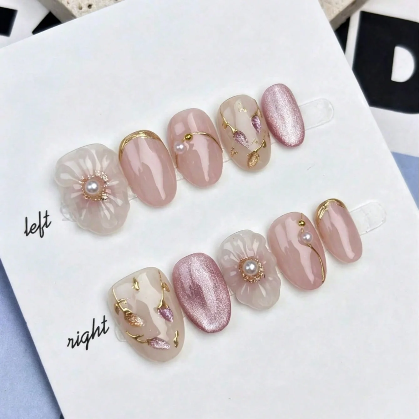 10 Stück mittelgroße ovale, hautfarbene, handbemalte 3D-Blumen-Press-On-Nägel mit Goldlinien, Perlen- und Katzenaugen-Akzenten für den Alltag, Hochzeiten und Brautmode.