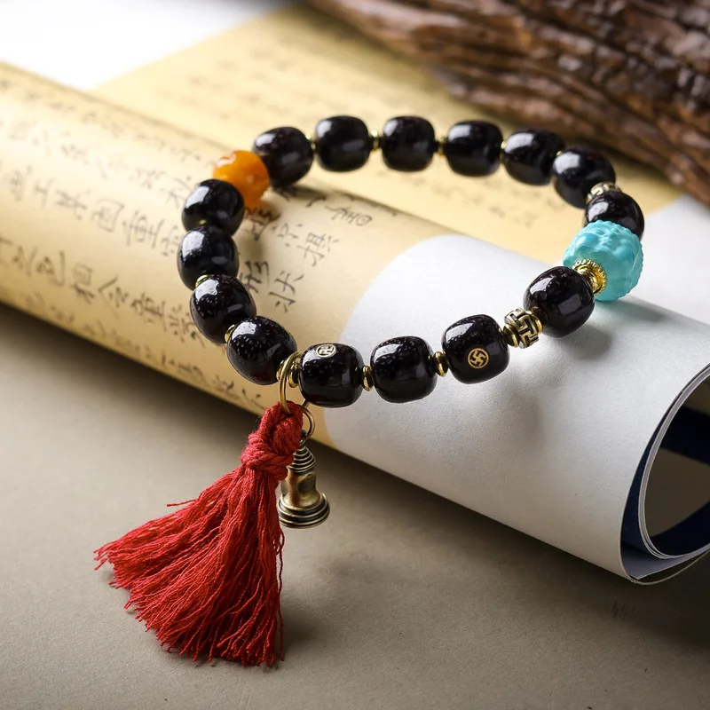 Cinnabar inlaid bracelet with a diamond-shaped pattern featuring magnesite turquoise and a Buddha head a traditional Chinese