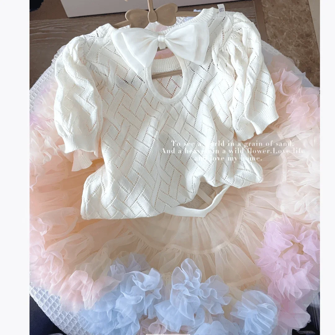

Girls' Short sleeved Ice Silk Thin Knitted Shirt Summer Fashion Children's Bow Hollow Bubble Sleeve T-shirt 2026 New
