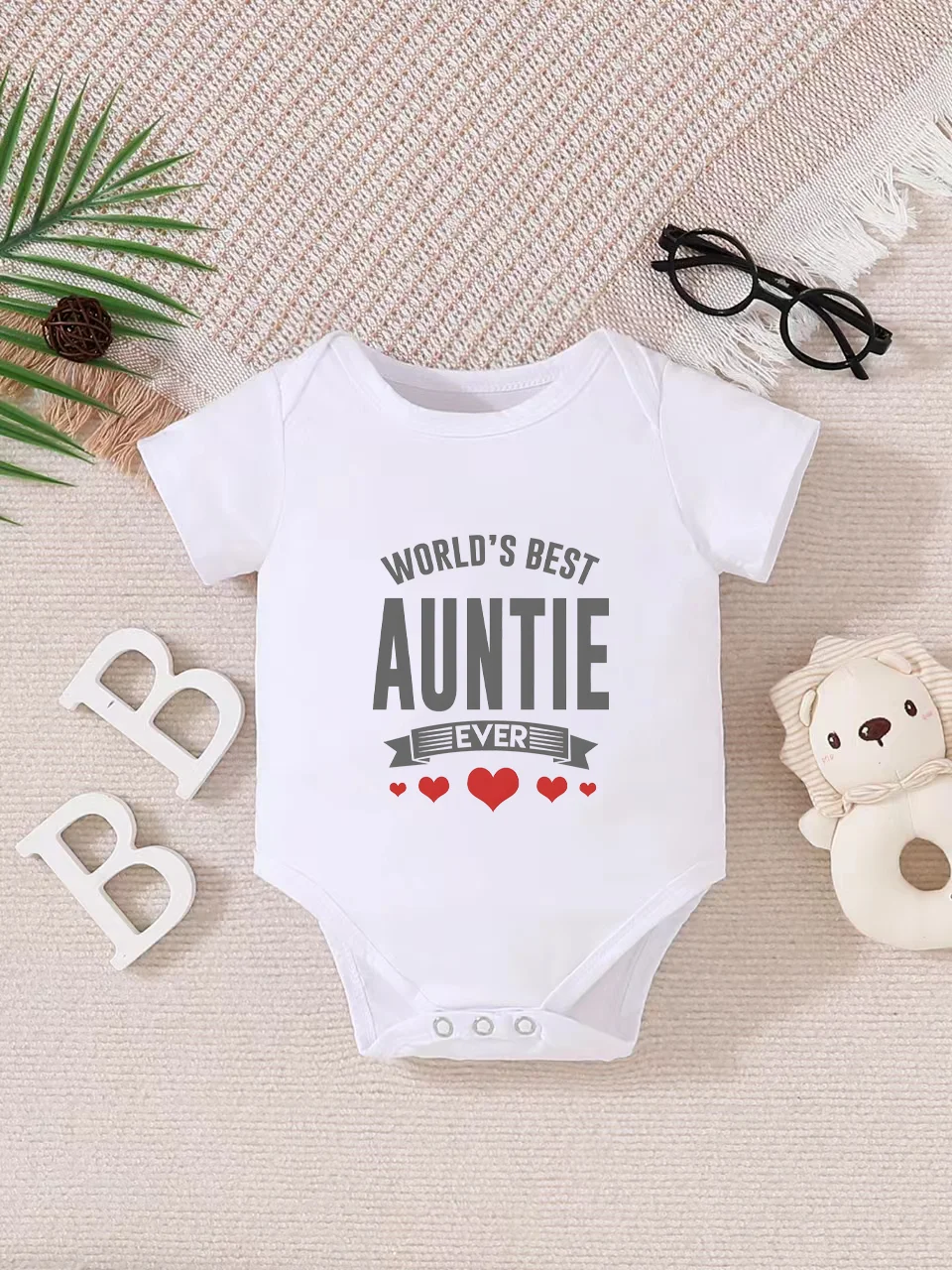 Playful letter-printed baby short-sleeve triangle bodysuit. Button closure for easy dressing, machine washable