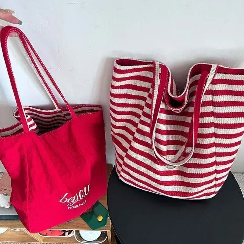

2025 double-sided striped canvas bag, niche Korean large capacity lazy style tote bag, student shopping bag, new handheld bag