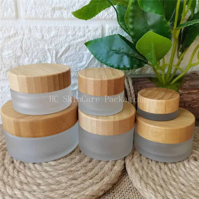 

High quality small empty clear frosted glass cosmetic packaging with bamboo screw lid glass jars for creamRefillablereacyclejar