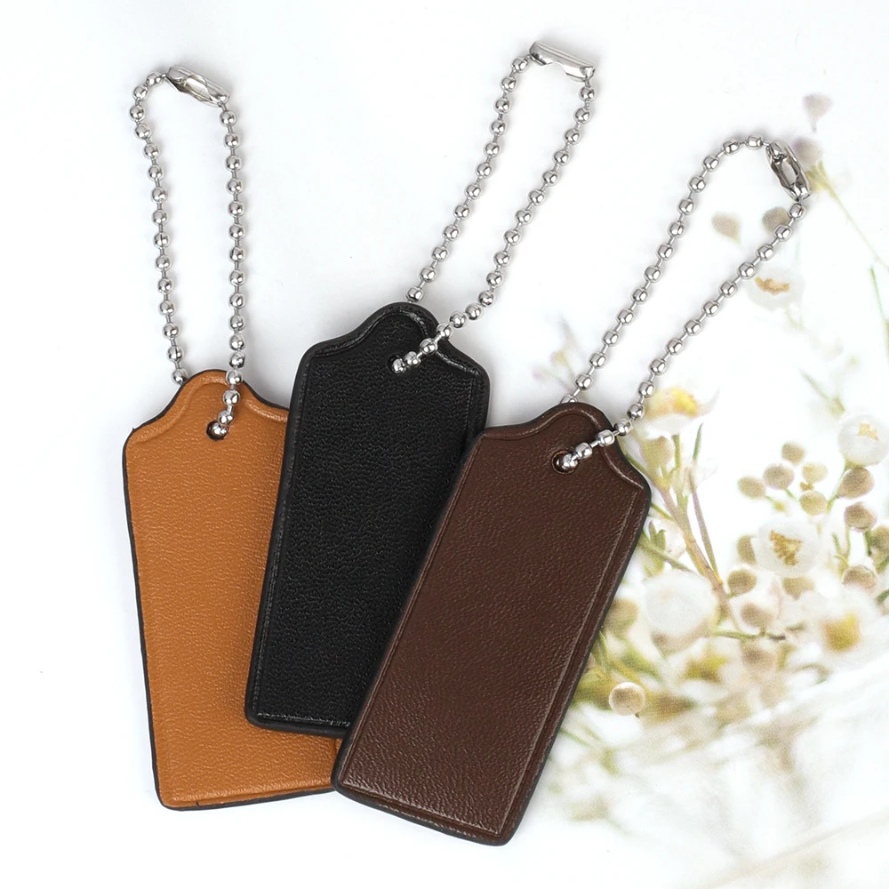 جلد البقر علامة الأمتعة حقيبة السفر العلامات أكياس الملحقات حقيبة جلدية حقيقية سحر سلسلة المفاتيح قلادة حقيبة يد محفظة شنق